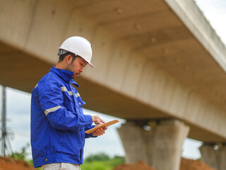 young engineer with the tablet controls the work on site