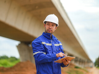 young engineer with the tablet controls the work on site