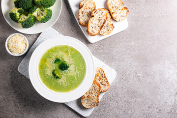 Warm and comforting creamy broccoli soup served in a bowl, garnished with parmesan cheese and croutons.