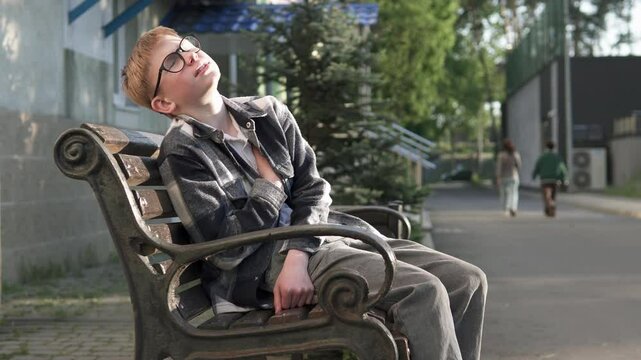 Boy feels sharp pain in heart after school bullying. Concepts of heart failure, stress and panic attack.