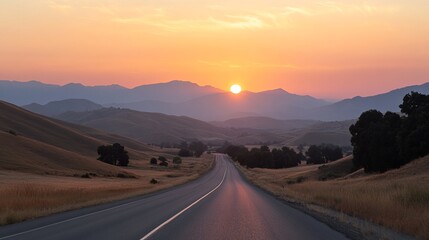 Fototapeta premium Serene sunset over a winding road through rolling hills and valleys