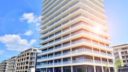 Exterior of a high modern multi-story apartment building - facade, windows and balconies.