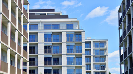 Modern apartment buildings on a sunny day with a blue sky. Facade of a modern apartment building....