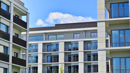 Modern apartment buildings on a sunny day with a blue sky. Facade of a modern apartment building. Modern residential apartment building complex condo.
