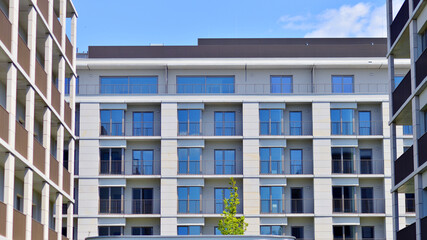 Modern apartment buildings on a sunny day with a blue sky. Facade of a modern apartment building. Modern residential apartment building complex condo.