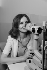 Woman undergoing professional eye exam with advanced ophthalmology diagnostic equipment