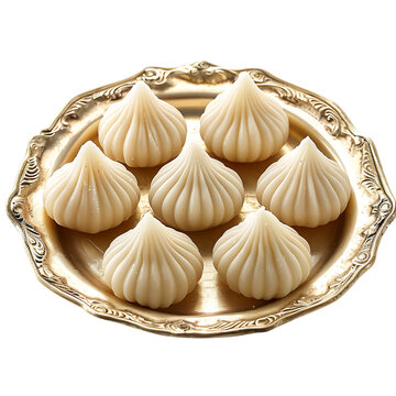 Traditional indian modak sweets arranged on a decorative golden plate isolated on transparent background