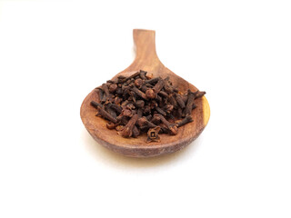 Whole Cloves in a wooden spoon isolated on white background, herbs and spices