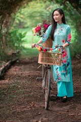 Young Vietnamese Girl with Bicycle Surrounded by Lush Nature