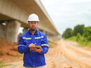 Asian engineer working with tablet at site of a large building project,Thailand people,Work...