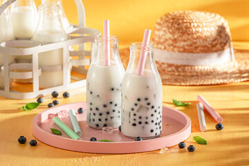 Tasty blueberry bubble tea with milkshake, balls and ice.