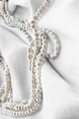 Pearl on white silk