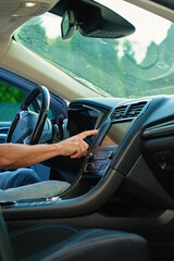 Hand pressing car engine start button. Starting vehicle using modern ignition technology. Person...