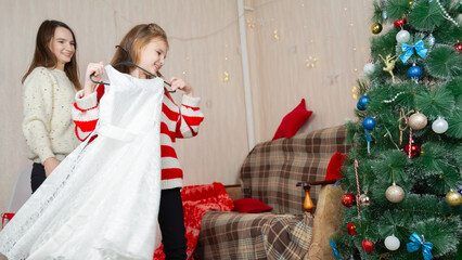 Daughter girl smiling with happiness, making and dressing up together, at cozy home