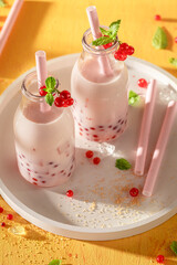 Fresh and chilled red currant bubble tea made of milk.