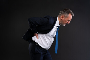 Man with lower back pain in business attire