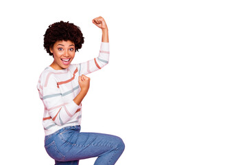 Profile photo of excited dark skin wavy lady raising fists celebrating black friday shopping wear...
