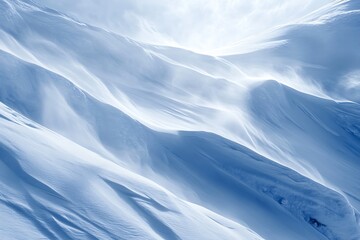 Abstract snow drifts and wind swept mountain slopes in soft blue light