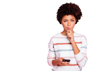 Photo of pretty dark skin lady holding telephone deciding what comment to write hand touch chin...