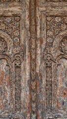 Naklejka premium Carved weathered wooden door