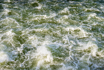 Aerial view of sea waves. Blue water background.