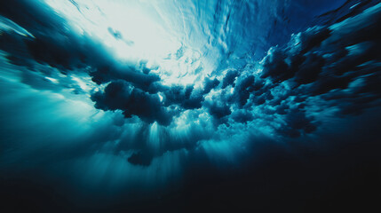 Tormenta submarina: burbujas y rayos de luz azul en el océano profundo, Vista subacuática de una ola rompiendo con estelas de espuma y haces solares