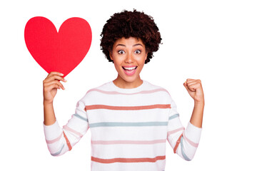 Photo of pretty dark skin lady holding in hands big red paper heart showing creative date surprise wear striped pullover isolated pastel pink color background