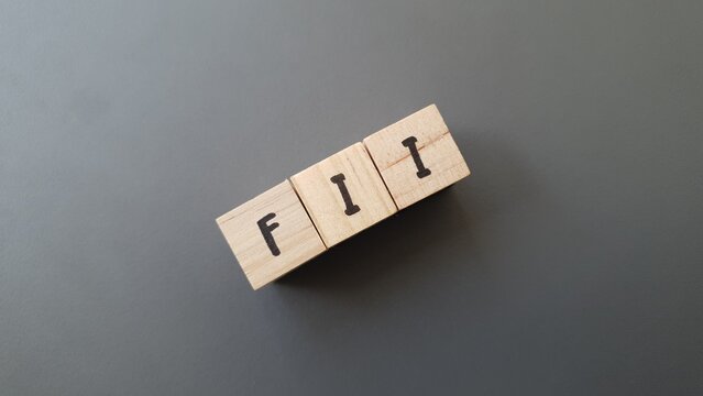 FII acronym made of wooden letter cubes on dark background. Fondo de Inversi&oacute;n Inmobiliaria (Real Estate Investment Fund)