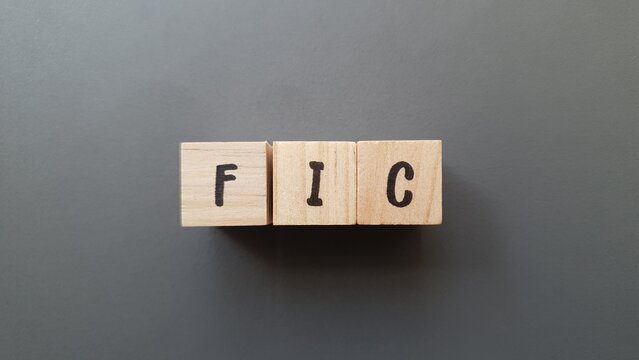 FIC acronym made of wooden letter cubes on dark background. Fondo de Inversi&oacute;n Colectiva (Collective Investment Fund)