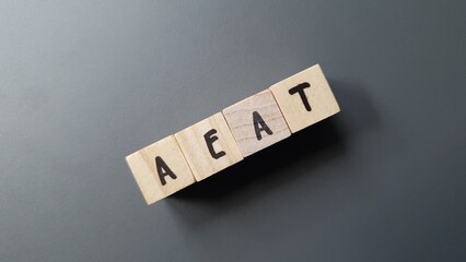 AEAT acronym made of wooden letter cubes on dark background. Agencia Española de Administración...