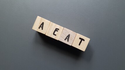 AEAT acronym made of wooden letter cubes on dark background. Agencia Española de Administración...