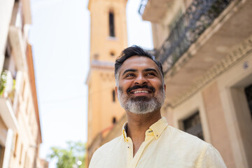 Indian man enjoying a sunny day as a tourist
