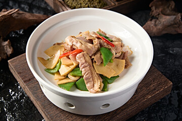 Chinese food: fried pork belly with bell pepper, onion and magnolia slices