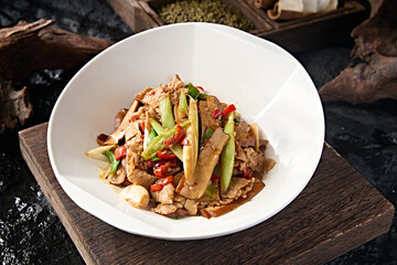 Chinese food stir-fried pork belly with rice pepper, garlic sprouts, garlic and dried tofu