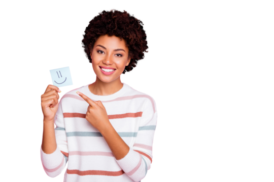 Photo of pretty dark curly skin lady holding in hands little paper emoticon directing finger what mood is better wear white striped pullover isolated pastel pink color background - Powered by Adobe