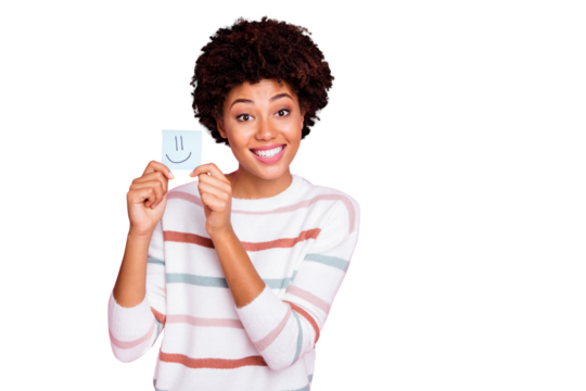 Photo of cheerful charming cute nice girlfriend black skinned holding piece of paper with emoji drawed on wearing white striped sweater isolated over pastel pink color background