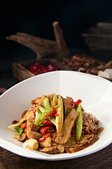Chinese food stir-fried pork belly with rice pepper, garlic sprouts, garlic and dried tofu