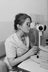 Woman undergoing professional eye exam with advanced ophthalmology diagnostic equipme