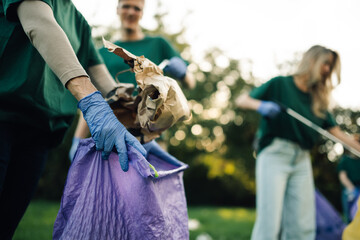 Group of volunteers collecting garbage in park