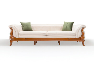 A luxurious cream-colored sofa with an ornate wooden frame and two green pillows. Front view studio shot, isolated on a white background.
