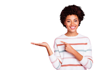 Photo of pretty dark skin wavy lady indicating finger on open palm advising new cheap product wear striped pullover isolated pastel pink color background
