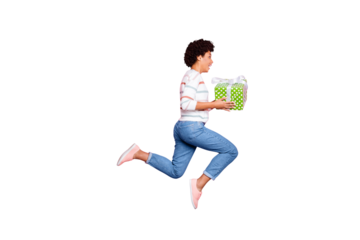 Full length body size photo of fashionable sweet crazy ecstatic runner holding gift box with her hands jumping running for sales in jeans denim sweater isolated pink pastel color background