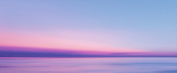 The serene ocean at sunset with beautiful pastel colors in the sky.