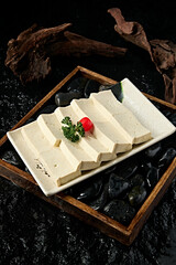 A plate of fresh soft tofu slices