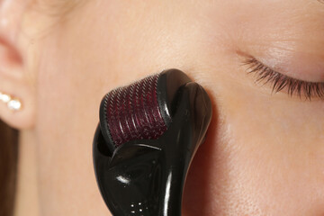 Facial massage with microneedle dermaroller for the treatment of scars, wrinkles and for facial...
