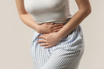 Woman having a painful stomach ache, chronic gastritis or abdomen bloating, upset stomach,...