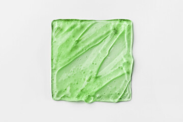 The texture of a green cosmetic gel on a white background