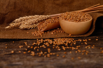 Ears of wheat and bowl of wheat grains