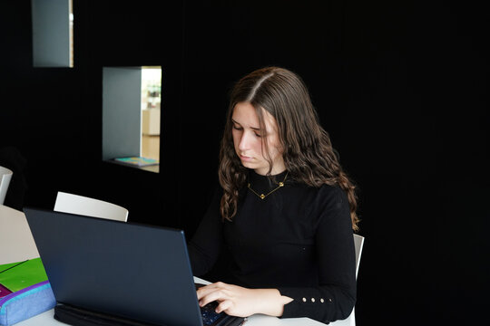 Teenage girl focused on laptop study in classroom