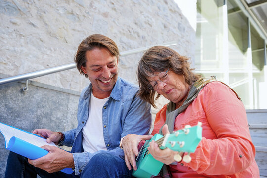 Elder teacher and student enjoying music lesson
